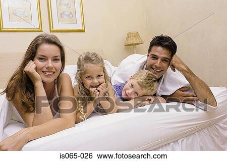 Family in bed View Large Photo Image Stock Image - Family in bed. Fotosearch - Search Stock Photography, Poster Photos, Pictures, and Photo Clip Art