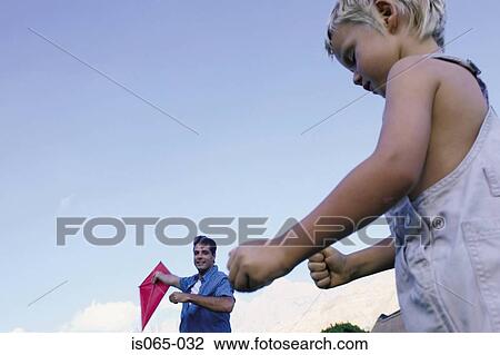 Father and son flying kite View Large Photo Image Stock Image - Father and son flying kite. Fotosearch