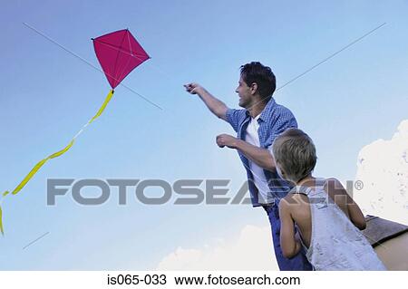 Father and son flying kite View Large Photo Image Stock Image - Father and son flying kite. Fotosearch