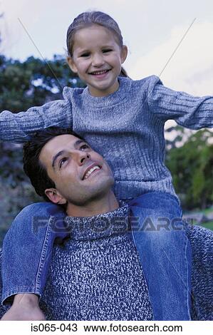 Stock Image - Father carrying daughter. Fotosearch