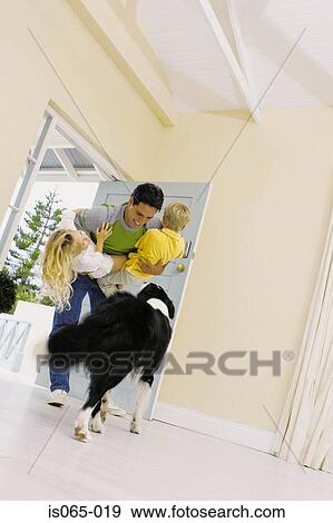 Stock Photo - Father holding children. Fotosearch