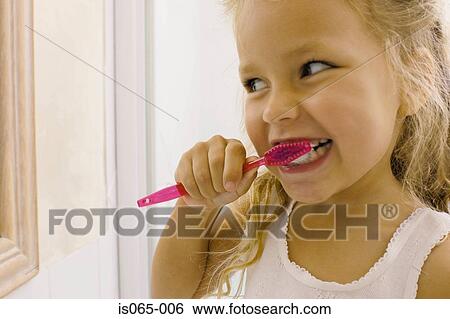 Stock Photograph - Girl brushing teeth. Fotosearch