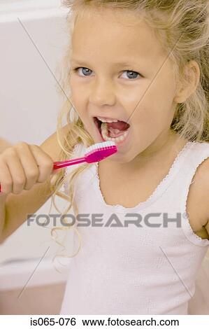 Stock Photograph - Girl brushing teeth. Fotosearch