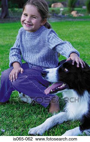 Stock Image - Girl stroking dog. Fotosearch