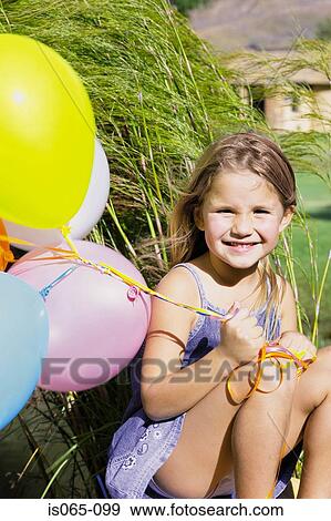 Girl with balloons View Large Photo Image Stock Photo - Girl with balloons. Fotosearch