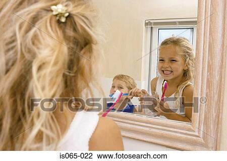 Stock Image - Kids brushing teeth. Fotosearch