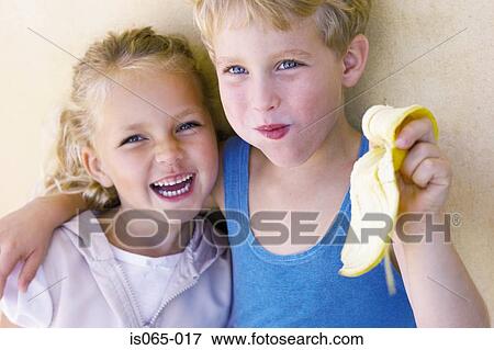 Stock Photo - Kids eating banana. Fotosearch