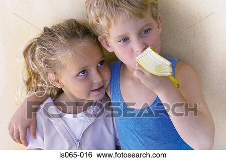 Kids eating banana View Large Photo Image Stock Photograph - Kids eating banana. Fotosearch