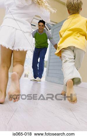 Kids running towards father View Large Photo Image Stock Photo - Kids running towards father. Fotosearch