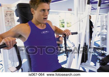 Picture - Man weight-training. Fotosearch