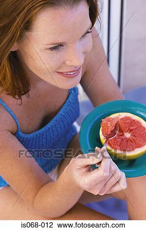 Girl eating grapefruit View Large Photo Image Stock Image - Girl eating grapefruit. Fotosearch