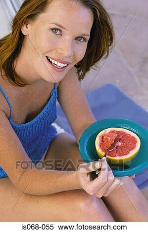Girl eating grapefruit View Large Photo Image Stock Photography - Girl eating grapefruit. Fotosearch
