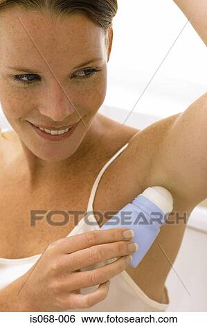Girl using deodorant View Large Photo Image Stock Photograph - Girl using deodorant. Fotosearch