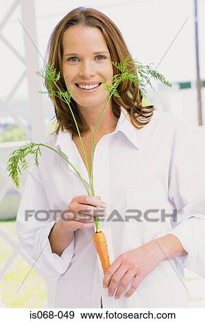 Girl with carrot View Large Photo Image Stock Photo - Girl with carrot. Fotosearch