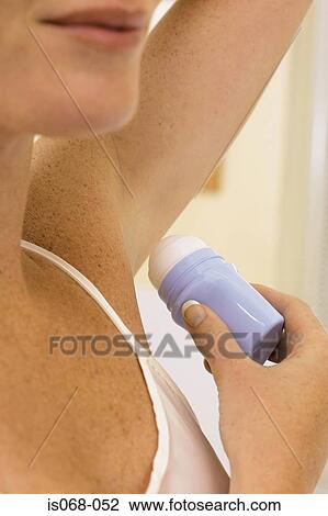 Woman using deodorant View Large Photo Image Stock Image - Woman using deodorant. Fotosearch