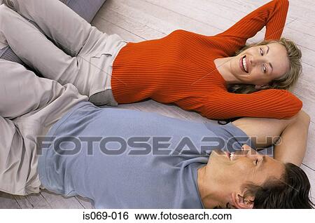 Stock Photograph - Couple lying on floor. Fotosearch