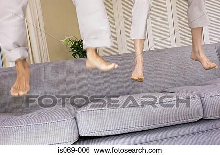 Feet bouncing on sofa View Large Photo Image Stock Photograph - Feet bouncing on sofa. Fotosearch