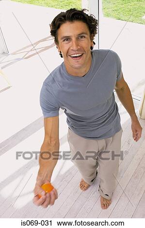 Man with orange View Large Photo Image Stock Image - Man with orange. Fotosearch