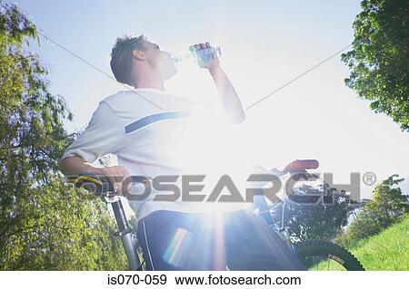 Man drinking water View Large Photo Image Stock Photo - Man drinking water. Fotosearch