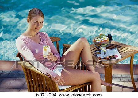 Woman relaxing at pool View Large Photo Image Picture - Woman relaxing at pool. Fotosearch