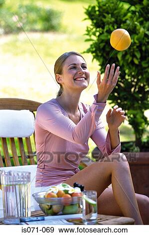 Woman with orange View Large Photo Image Stock Photo - Woman with orange. Fotosearch