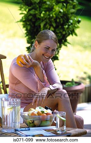 Woman with orange View Large Photo Image Stock Photo - Woman with orange. Fotosearch