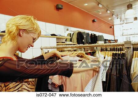 Girl in clothes shop View Large Photo Image Stock Photo - Girl in clothes shop. Fotosearch