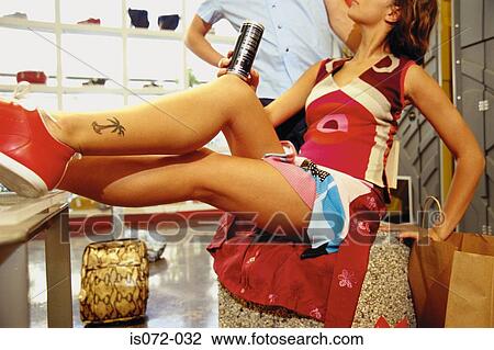 Stock Image - People in shoe shop. Fotosearch