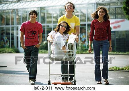 Teenagers with shopping trolley View Large Photo Image Stock Image - Teenagers with shopping trolley. Fotosearch