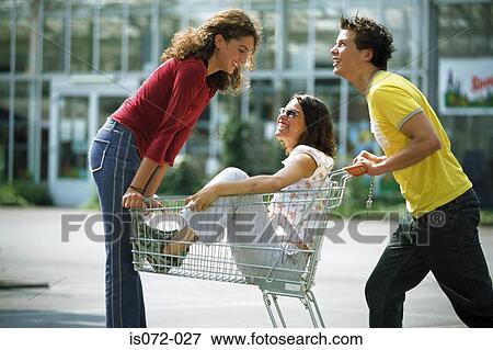 Teenagers with shopping trolley View Large Photo Image Stock Photo - Teenagers with shopping trolley. Fotosearch