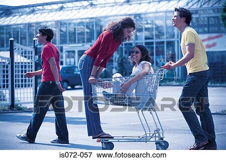 Teenagers with shopping trolley View Large Photo Image Stock Photo - Teenagers with shopping trolley. Fotosearch