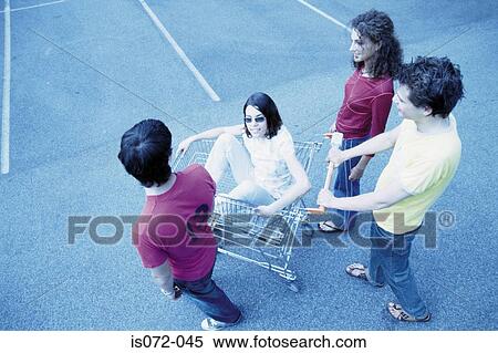 Teenagers with shopping trolley View Large Photo Image Stock Photography - Teenagers with shopping trolley. Fotosearch