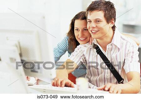 Stock Photo - Couple at computer. Fotosearch