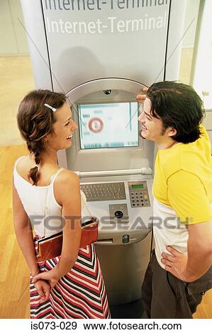 Couple at Internet terminal View Large Photo Image Stock Photo - Couple at Internet terminal. Fotosearch