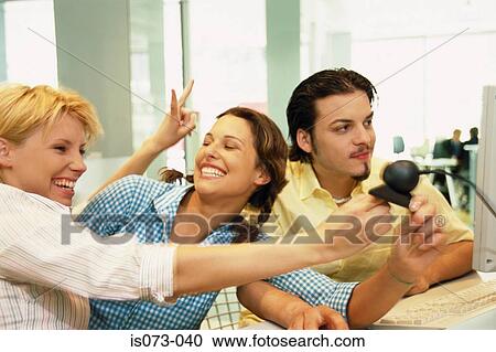 Stock Image - Friends at computer. Fotosearch
