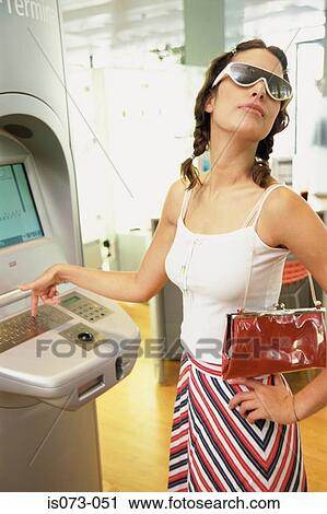 Stock Image - Girl at Internet terminal. Fotosearch