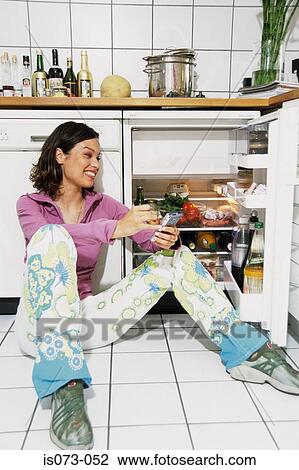 Stock Image - Girl in kitchen. Fotosearch