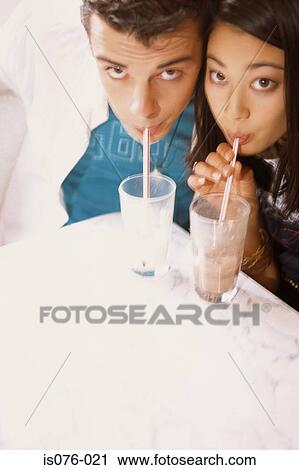 Couple drinking milkshakes View Large Photo Image Stock Image - Couple drinking milkshakes. Fotosearch