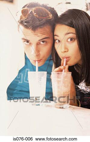 Couple drinking milkshakes View Large Photo Image Stock Photograph - Couple drinking milkshakes. Fotosearch