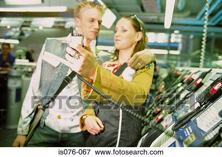 Stock Photo - Couple in mobile phone shop. Fotosearch