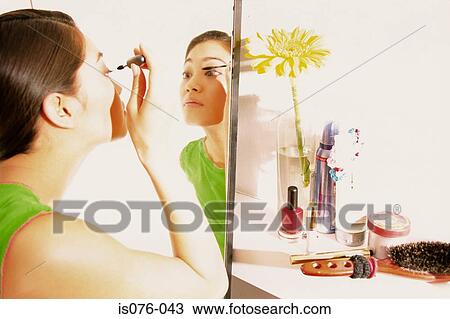 Stock Image - Girl applying mascara. Fotosearch