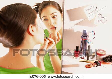 Stock Photography - Girl painting lips. Fotosearch