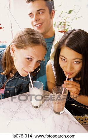 Picture - Girls drinking milkshakes. Fotosearch