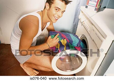 Man emptying washing machine View Large Photo Image Stock Image - Man emptying washing machine. Fotosearch