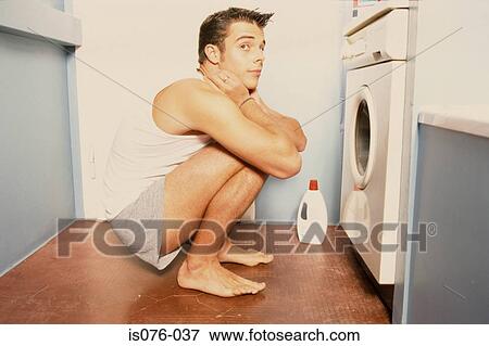 Man in front of washing machine View Large Photo Image Stock Photo - Man in front of washing machine. Fotosearch