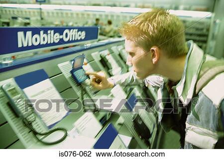 Man in mobile phone shop View Large Photo Image Stock Image - Man in mobile phone shop. Fotosearch
