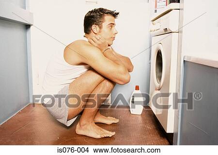 Man watching washing machine View Large Photo Image Picture - Man watching washing machine. Fotosearch