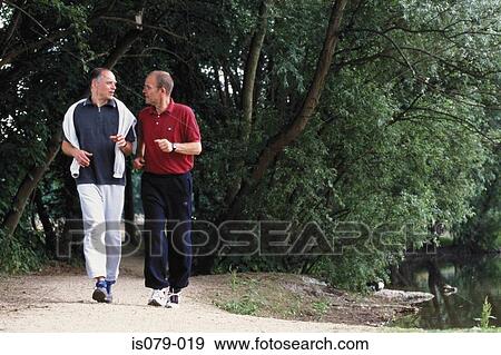 Men walking in wood View Large Photo Image Stock Photo - Men walking in wood. Fotosearch