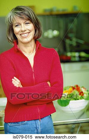 Stock Photography - Woman in kitchen. Fotosearch