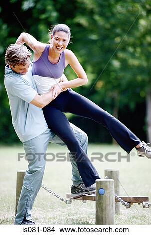 Couple on obstacle course View Large Photo Image Picture - Couple on obstacle course. Fotosearch